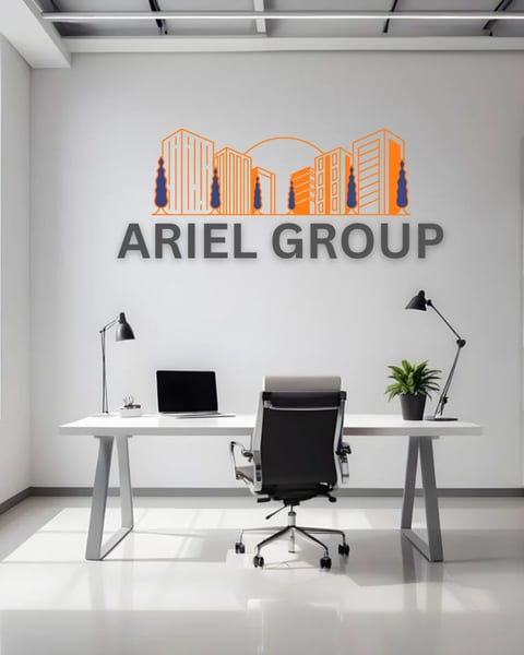 Ariel Group office reception with modern desk, black chair, desk lamps, potted plant, and colorful company logo on white wall